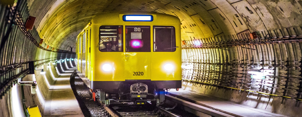 yellow colored train in a tunnel